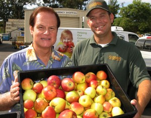 Food Bank 2014 and 2 people holding a box of apples