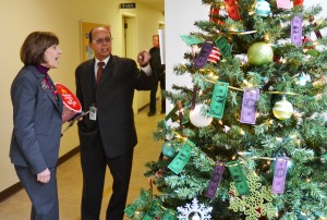 At the department's "Chem Lab" in the Meadowview community of Sacramento, Nirmal Saini describes the "Christmas Dollar Drive" theme, benefitting (1) the annual state employee food drive, (2) the Sacramento Public Library, (3) Women Escaping a Violent Environment (WEAVE), and (4) Fieldhaven Feline Rescue.