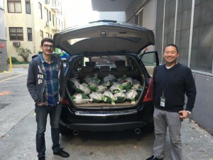 CDFA employees Brandon Morrow and Darrin Okimoto standing in front of an vehicle