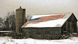 A barn with an American flag on the roof