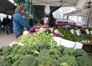 A woman shopping for vegetables at a market