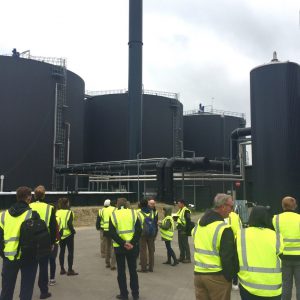 The delegation and digesters at the Midtfyn Biogas Plant in Ringe, Denmark